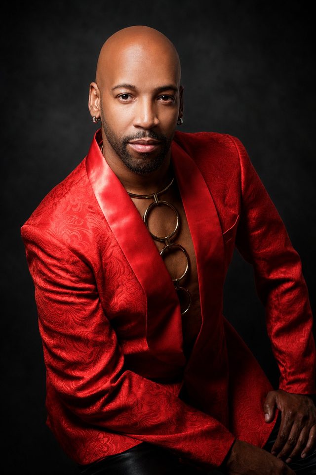 Antonio Edwards in a red brocade jacket