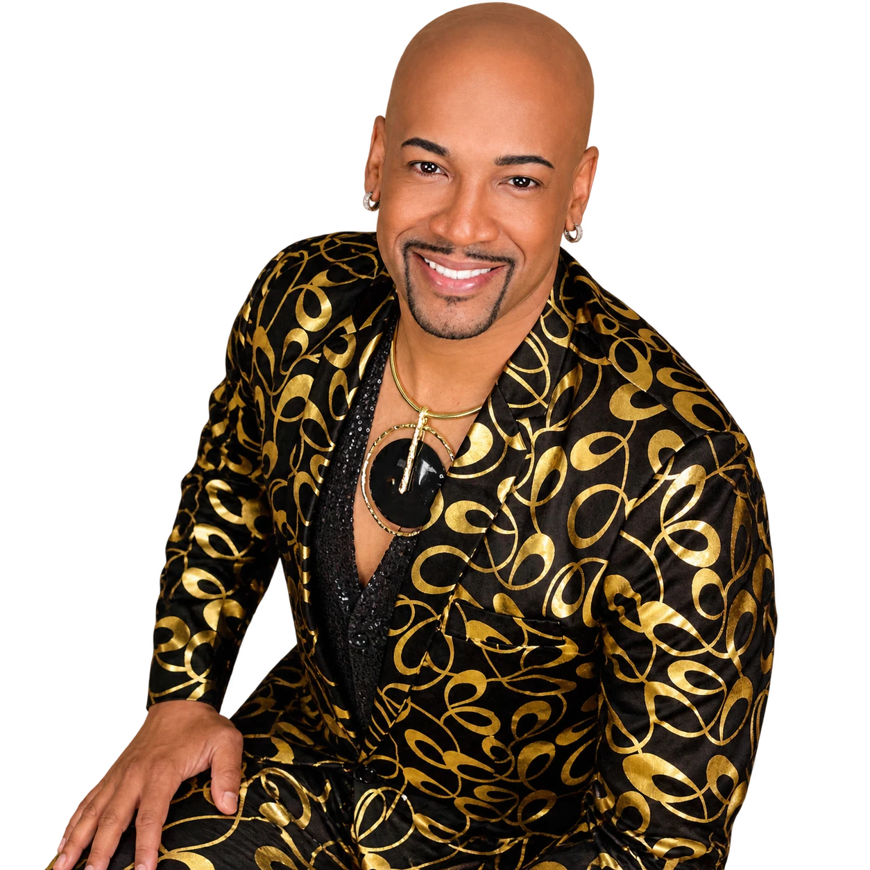 Antonio Edwards smiling in a black and gold suit