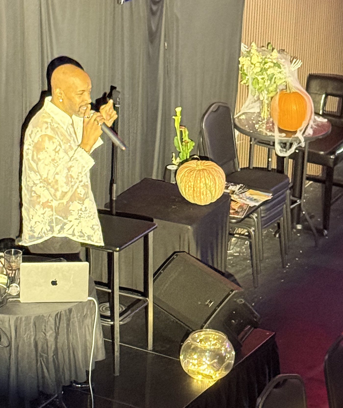 Antonio singing in a sheer lace shirt at Tap That